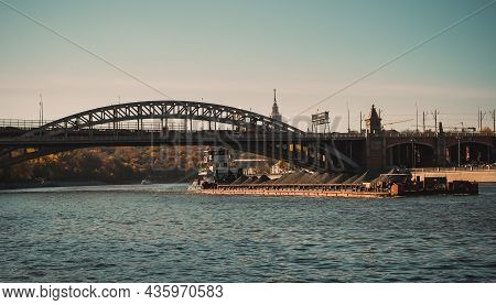 Barge Loaded With Black Coal Floats On The Moscow River. Cargo Ship Cruising On The Moskva River, Ca