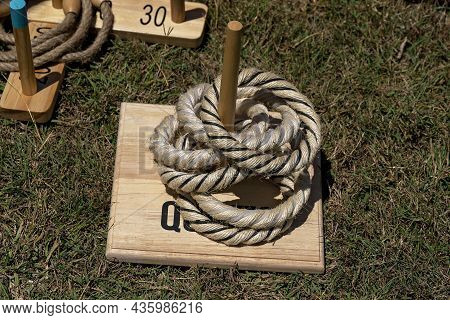 A Game Of Quoits On The Grass At A Country Fair