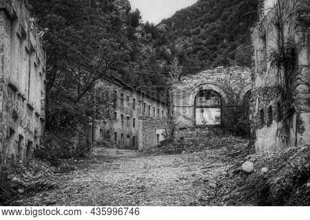 View Along Former Street Of Ruined By Mudflow Old Town In Mountains With Partially Collapsed Buildin