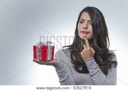 Woman Looking At A Gift With A Puzzled Look