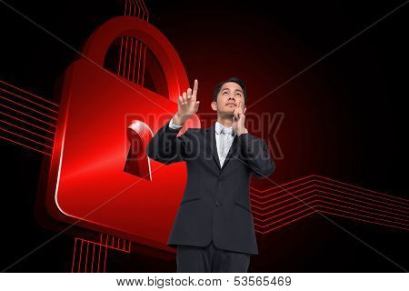 Composite image of thouhgtful asian businessman pointing