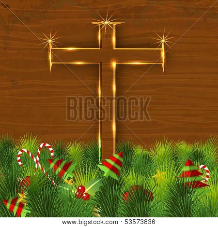 Merry Christmas celebration concept with golden wooden Christian Cross on green grass background with little Xmas trees. 