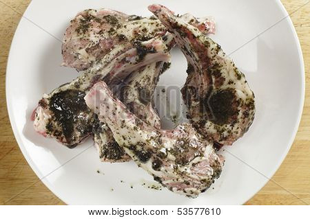 Lamb chops coated with a mint marinade ready to go on a  barbecue grill
