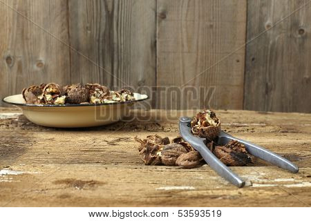 Walnuts Cracked Open With Old Nut Cracker In A Vintage Plate On A Wooden Table