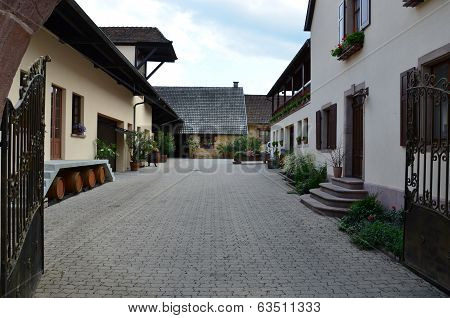 Street with half-timbered medieval houses in Eguisheim village along the famous wine route in Alsace