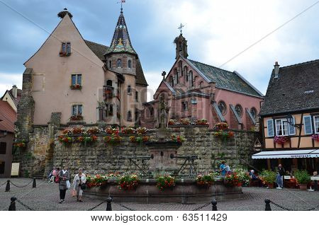 Street with half-timbered medieval houses in Eguisheim village along the famous wine route in Alsace
