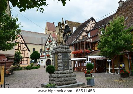 Street with half-timbered medieval houses in Eguisheim village along the famous wine route in Alsace