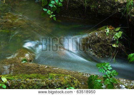 Creek pentrating through a whirlpool