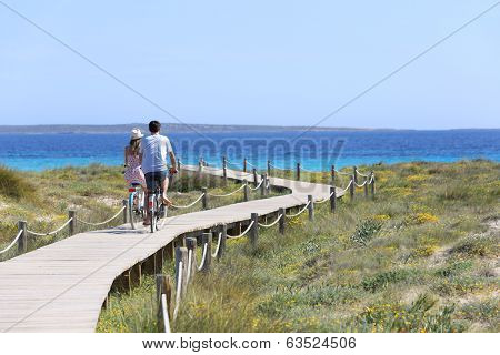 Couple riding bikes on Formentera Island