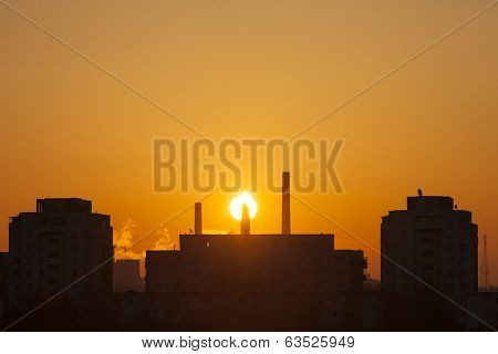 Winter Scenic Of Power Plant With A Burning Red Clouds Behind