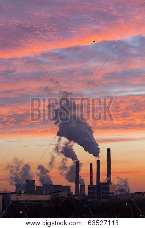 Winter Scenic Of Power Plant With A Burning Red Clouds Behind
