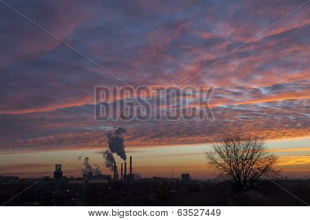 Winter Scenic Of Power Plant With A Burning Red Clouds Behind