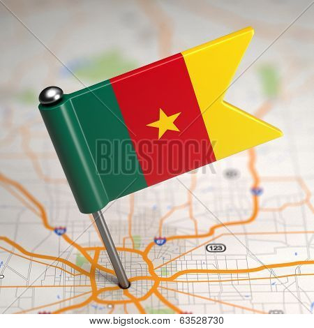 Cameroon Small Flag on a Map Background.