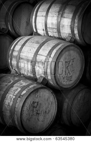 Wine barrels stacked in the old cellar of the winery.