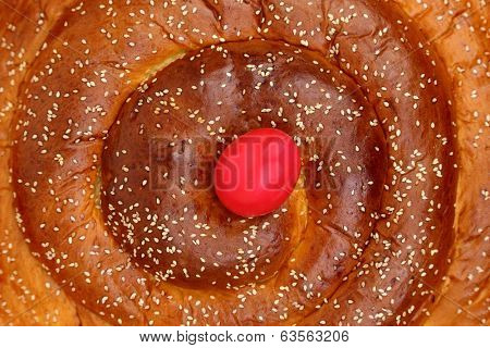 Macro shot of Easter sweet brioche with a red egg 