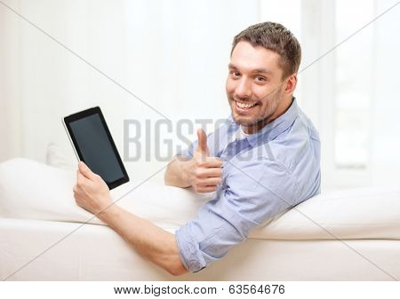 technology, home and lifestyle concept - smiling man working with tablet pc computer at home showing thumbs up