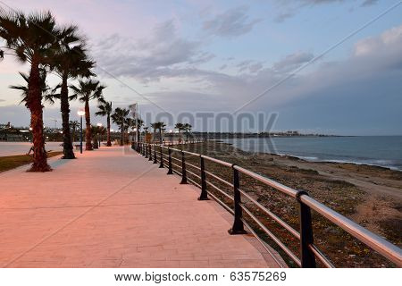 Stone beach promenade at sunset
