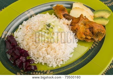 chicken served with white rice potato on a plate
