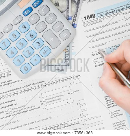 Man Filling Out 1040 Us Tax Form - View From Top