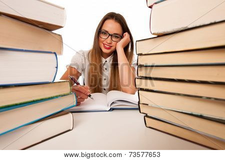 Happy Asian Caucasian Girl Lerning In Study Woth Lots Of Books On The Table