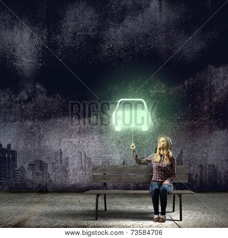 Young teenager girl sitting on bench with balloon in hand