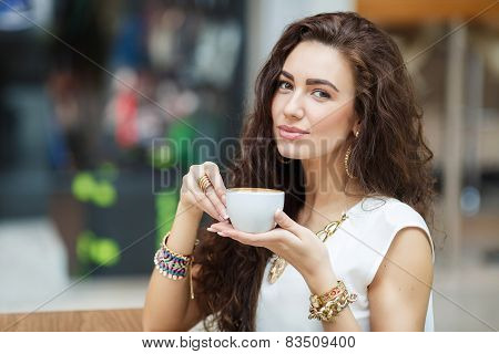 Woman drinking coffee in a cafe supermarket.