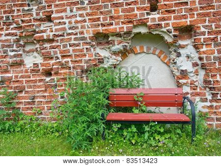 Red Bench by medieval 13th century brick ruin