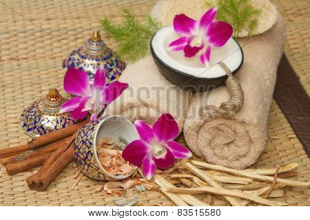 Thai Spa Massage Setting With Spa  Essential Oil , Towel, Herb ,natural Luffa Sponge And With Orchid