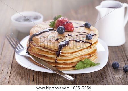 Delicious sweet French pancakes on a plate with fresh fruits