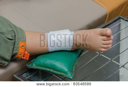 Child Boy With Bandage On Leg And Lying Down Hospital Bed