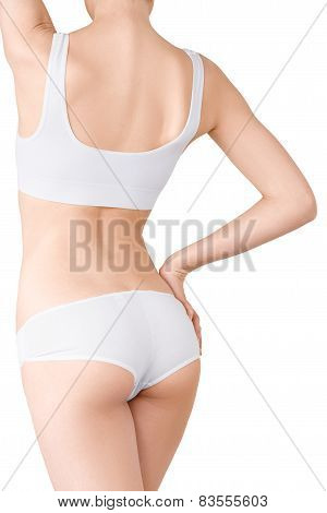 Woman with perfect slim body in white underwear isolated on white.