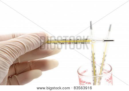 Thermometer In Doctor's Hand On White Background