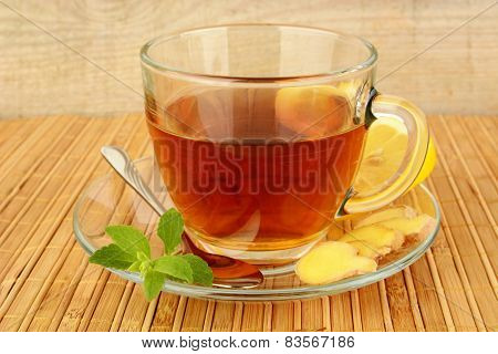 Ginger Tea-ingwertee On Wooden Mat With Lemon