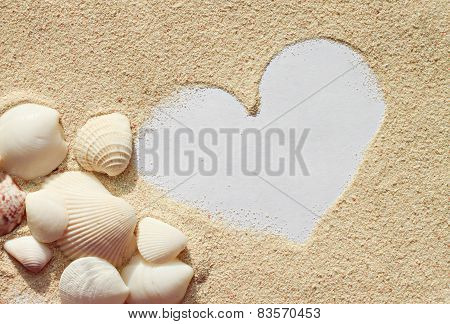 Heart on sand with seashells