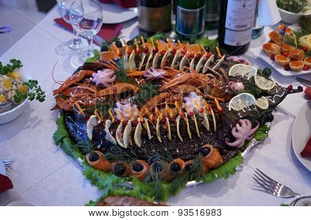 A dish of roasted pike, crabs, salmon and octopus