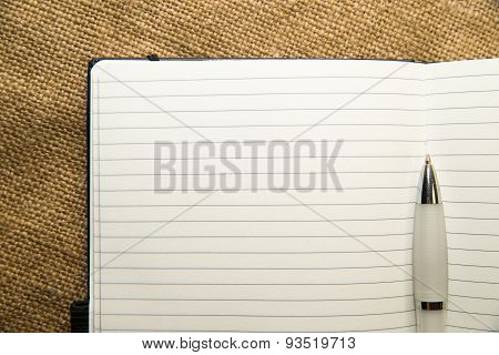 Opened Notebook And Pen On The Old Tissue