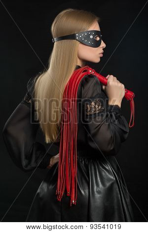 girl with red leather whip and mask BDSM