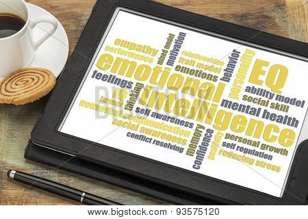 emotional intelligence (EQ) word cloud on a digital tablet with a cup of coffee