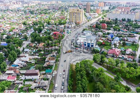 Aerial city view on crossroad, carshop and houses