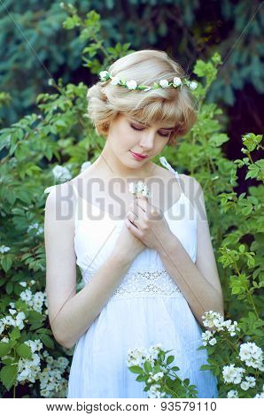 Beautiful Blonde Woman In White Sundress Posing In Garden