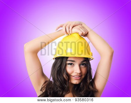 Young woman with hellow hard hat against gradient 