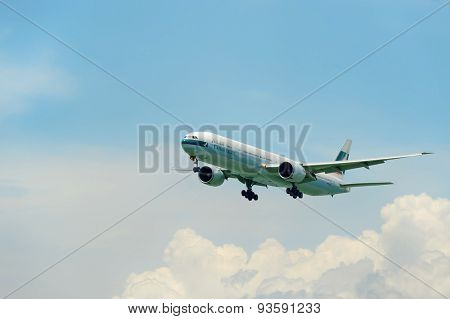 HONG KONG - JUNE 04, 2015: Cathay Pacific aircraft landing. Cathay Pacific is the flag carrier airline of Hong Kong, with its head office and main hub located at Hong Kong International Airport