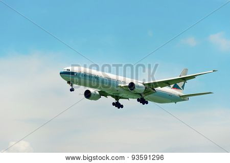HONG KONG - JUNE 04, 2015: Cathay Pacific aircraft landing. Cathay Pacific is the flag carrier airline of Hong Kong, with its head office and main hub located at Hong Kong International Airport