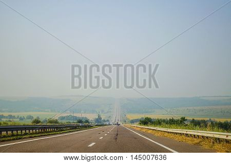 paved picturesque road leading into the distance in the summer