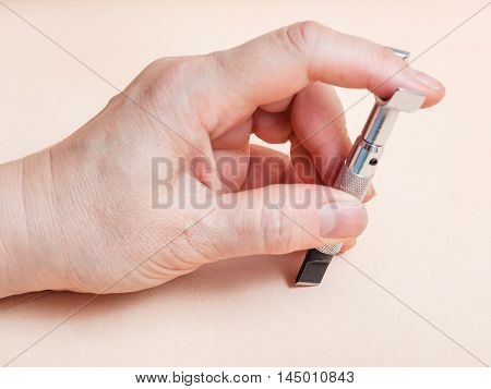 Hand With Swivel Knife On Natural Leather
