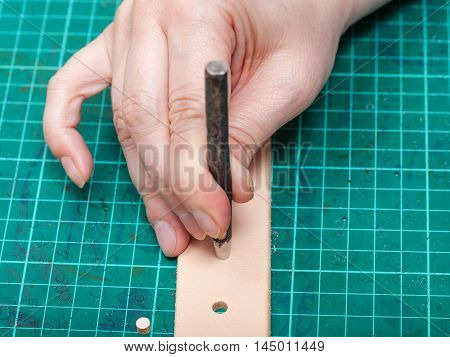 Punching Hole In New Belt With Steel Punch