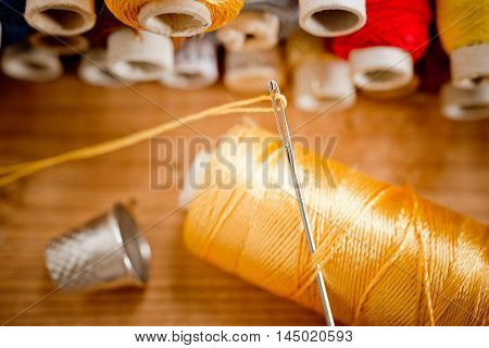 sewing kit on the old wooden desk