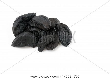 Close up of succulent; Black Garlic cloves latest wonder food rich in antioxidants vitamins and minerals. On a isolated white background