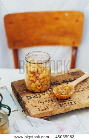 Raspberries Jam. Female Hand Making Jam, On A Rustic White Table