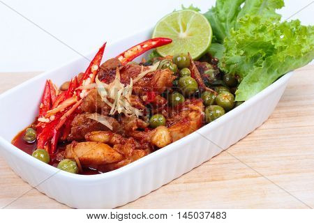 Spicy fried chicken in roasted chili sauce on selective focus.